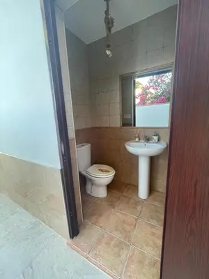 a bathroom with a toilet and a sink at Chalet con piscina in Chiclana de la Frontera