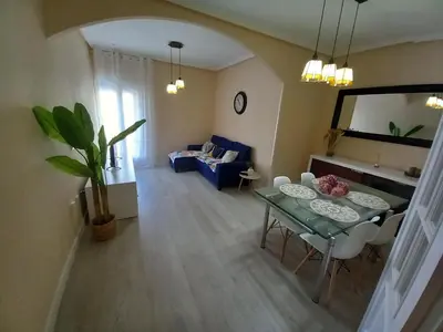 a living room with a table and a couch at Apartamento Centro Estación, Parking Privado in El Puerto de Santa María