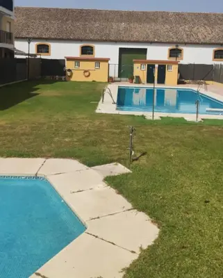 an empty swimming pool in the yard of a house at Apartamento Centro Estación, Parking Privado in El Puerto de Santa María