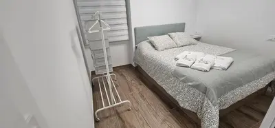 a bedroom with a bed with two pillows at Casa Plaza Alta in Alcalá de los Gazules