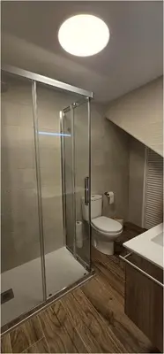 a bathroom with a glass shower and a toilet at Casa Plaza Alta in Alcalá de los Gazules