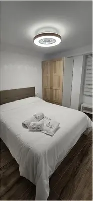 a bedroom with a bed with two towels on it at Casa Plaza Alta in Alcalá de los Gazules
