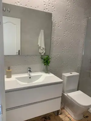 a bathroom with a sink and a toilet and a mirror at Chalet junto a la playa en Costa Sancti Petri in Chiclana de la Frontera