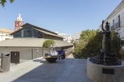 a statue of a woman on a fountain in a courtyard at BRUJULA ground floor indoor apartment by Cadiz4Rentals in Cádiz