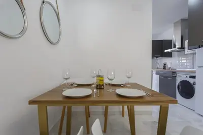 a dining room table with wine glasses on it at BRUJULA ground floor indoor apartment by Cadiz4Rentals in Cádiz