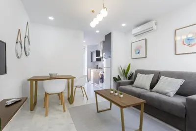 a living room with a couch and a table at BRUJULA ground floor indoor apartment by Cadiz4Rentals in Cádiz