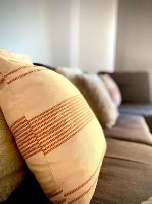 a pillow sitting on a couch in a living room at MyChoice San Francisco in Rota