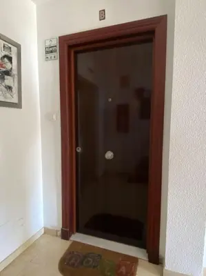a glass door in a room with a rug at MyChoice San Francisco in Rota