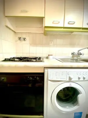 a kitchen with a washing machine and a stove at MyChoice San Francisco in Rota