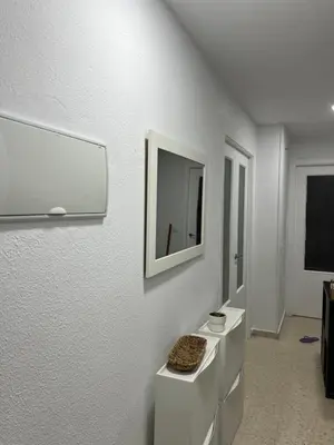 a white room with a tv and a white wall at La Bahía playa in El Trocadero