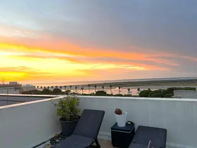 two chairs on a balcony with a view of the beach at La Bahía playa in El Trocadero