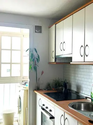a kitchen with white cabinets and a sink at La Bahía playa in El Trocadero
