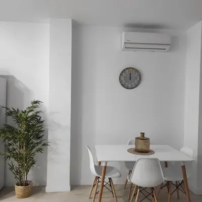 a white dining room with a white table and chairs at Ohana 2 in San Fernando