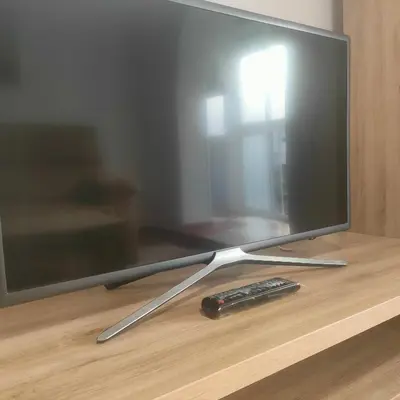 a remote control sitting on a table next to a tv at Apartamento Playa Tanguillos del Mar in Cádiz