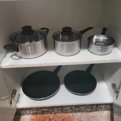 four pots and pans on a stove in a kitchen at Apartamento Playa Tanguillos del Mar in Cádiz
