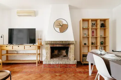 a living room with a fireplace and a television at Fabiana in Chiclana de la Frontera