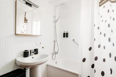 a white bathroom with a sink and a shower at Fabiana in Chiclana de la Frontera