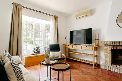 a living room with a fireplace and a tv at Fabiana in Chiclana de la Frontera