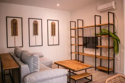 a living room with a couch and a table at Apartamentos Ribera del Rio 36 in El Puerto de Santa María
