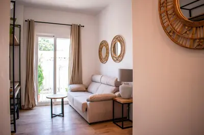 a living room with a couch and a table at Apartamentos Ribera del Rio 36 in El Puerto de Santa María