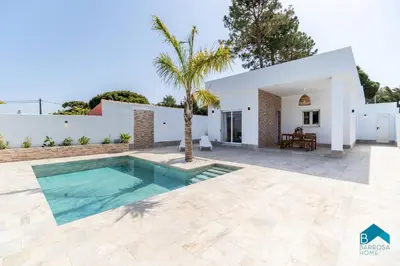 an image of a villa with a swimming pool at Adosados del Tio Pepe in Chiclana de la Frontera