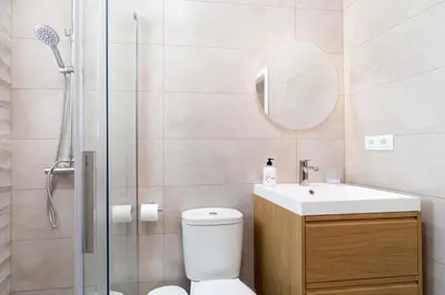 a bathroom with a toilet and a sink and a shower at Adosados del Tio Pepe in Chiclana de la Frontera