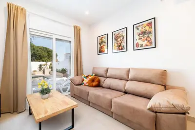 a living room with a couch and a table at Adosados del Tio Pepe in Chiclana de la Frontera