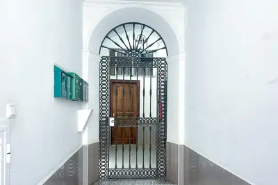 a gate in a stairway with a door in a building at Sanlúcarsun Apartamento en el centro in Sanlúcar de Barrameda