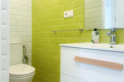 a bathroom with a toilet and a sink at Sanlúcarsun Apartamento en el centro in Sanlúcar de Barrameda