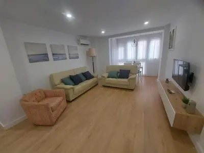 a living room with two couches and a tv at Aires de Cadiz Apartamento a estrenar in Cádiz