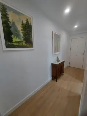 a room with a painting on the wall and a table at Aires de Cadiz Apartamento a estrenar in Cádiz