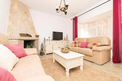 a living room with two couches and a tv at La Redondela in Chiclana de la Frontera