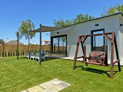a yard with a swing and a house at Casa Las Mironas I - Ole Solutions in El Puerto de Santa María