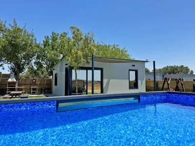 a small house with a swimming pool in front of a house at Casa Las Mironas I - Ole Solutions in El Puerto de Santa María