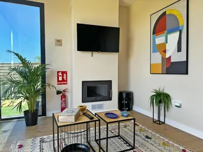 a living room with a tv and a table at Casa Las Mironas I - Ole Solutions in El Puerto de Santa María