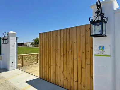 a wooden fence with a light on the side of a house at Casa Las Mironas I - Ole Solutions in El Puerto de Santa María