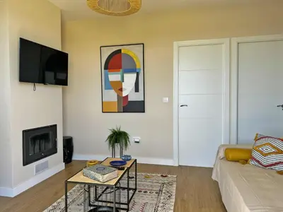 a living room with a couch and a tv at Casa Las Mironas I - Ole Solutions in El Puerto de Santa María