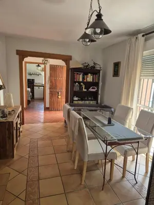 a dining room with a table and chairs at Chalet vacacional in El Puerto de Santa María