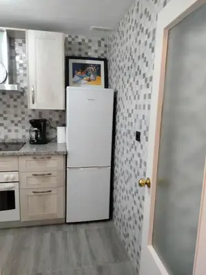 a kitchen with a white refrigerator in a room at apartamento en Puerto Real in El Trocadero
