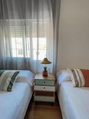 two twin beds in a room with a window at Apartamento Federico Deluxe con Terraza y garaje in El Puerto de Santa María