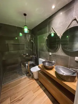 a bathroom with two sinks on a counter and a toilet at Apartamento Federico Deluxe con Terraza y garaje in El Puerto de Santa María
