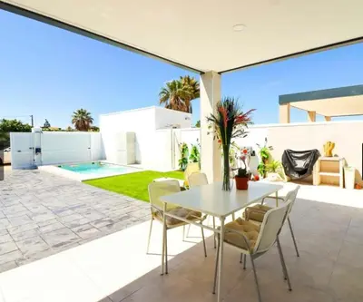 a patio with a white table and chairs at Trix I in Chiclana de la Frontera