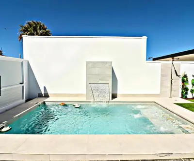 a swimming pool in the backyard of a house at Trix I in Chiclana de la Frontera