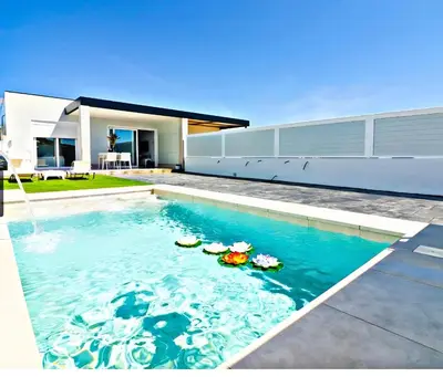 a swimming pool in front of a house at Trix I in Chiclana de la Frontera