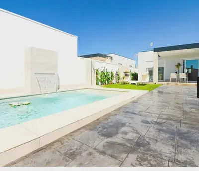 a swimming pool in the backyard of a house at Trix I in Chiclana de la Frontera