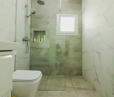 a bathroom with a shower with a toilet and a window at Trix I in Chiclana de la Frontera