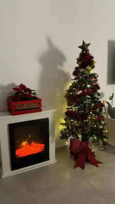 a christmas tree in a living room with a fireplace at Trix I in Chiclana de la Frontera