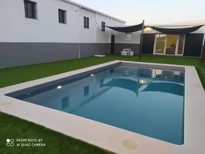 a swimming pool in the yard of a house at Apartamento la antigua via in Bonanza