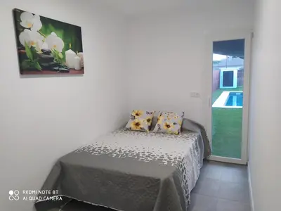 a bedroom with a bed and a picture on the wall at Apartamento la antigua via in Bonanza