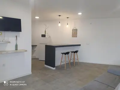 a kitchen with a counter and stools in a room at Apartamento la antigua via in Bonanza